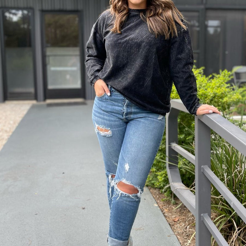 a long-sleeve ribbed textured pullover with a crew neck collar, a vintage wash, and a relaxed fit in black