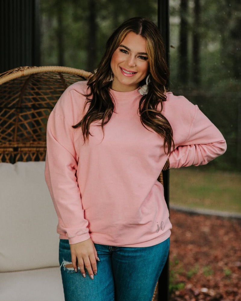 a long-sleeve ribbed textured pullover with a crew neck collar, a vintage wash, and a relaxed fit in blush