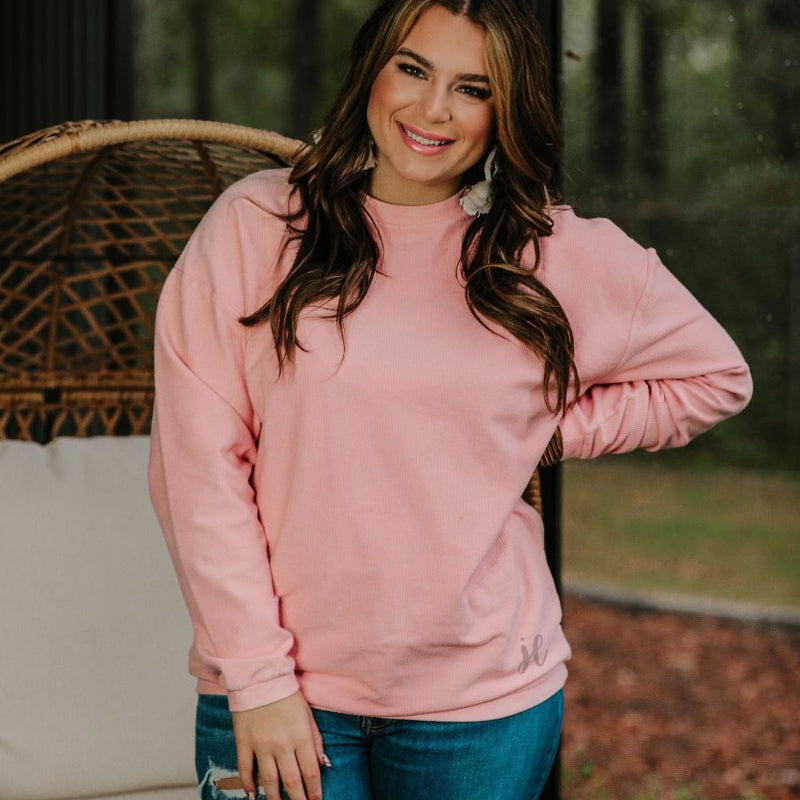 a long-sleeve ribbed textured pullover with a crew neck collar, a vintage wash, and a relaxed fit in blush