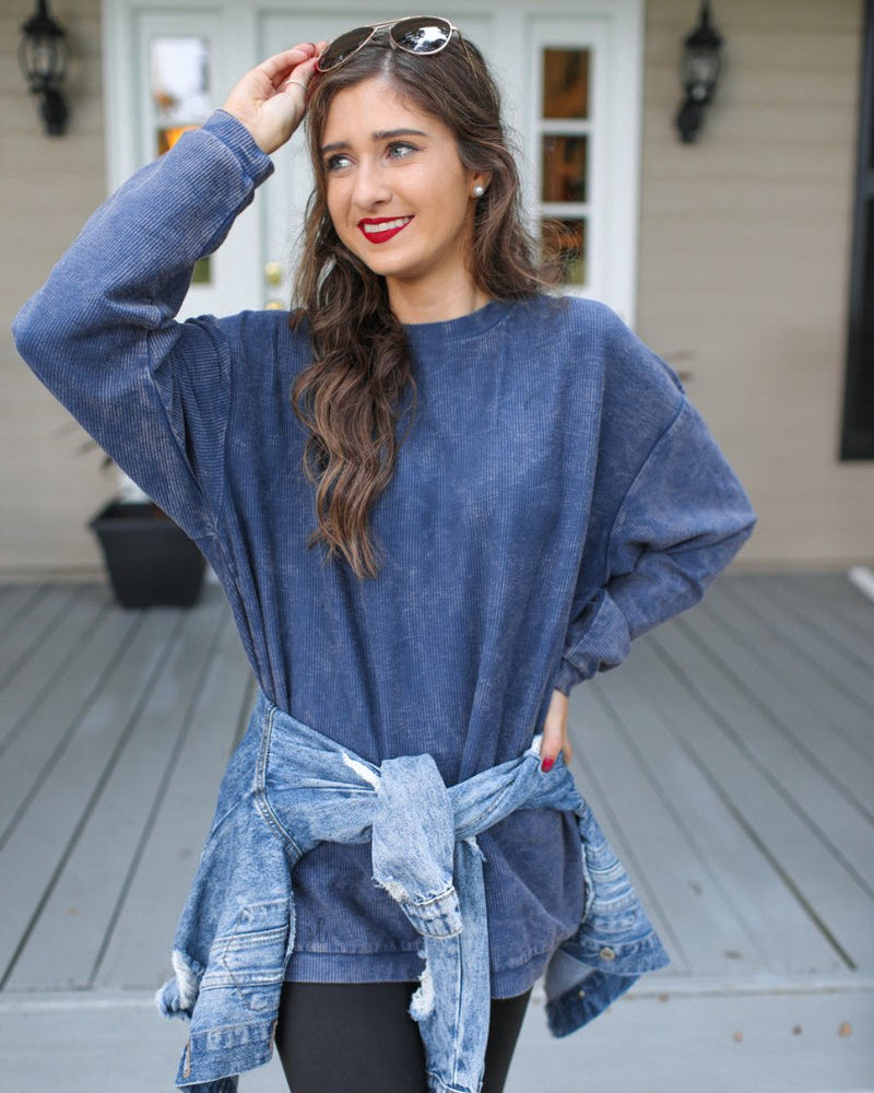a long-sleeve ribbed textured pullover with a crew neck collar, a vintage wash, and a relaxed fit in navy