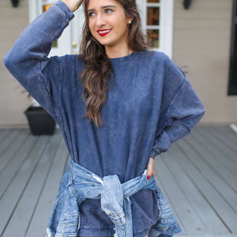 a long-sleeve ribbed textured pullover with a crew neck collar, a vintage wash, and a relaxed fit in navy
