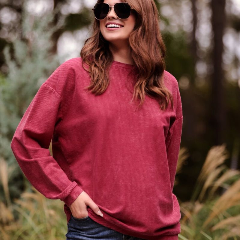 a long-sleeve ribbed textured pullover with a crew neck collar, a vintage wash, and a relaxed fit in red