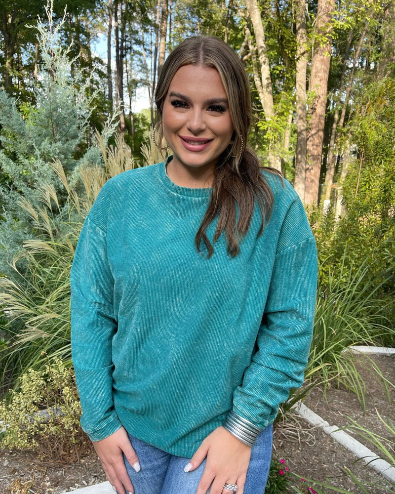 a long-sleeve ribbed textured pullover with a crew neck collar, a vintage wash, and a relaxed fit in teal