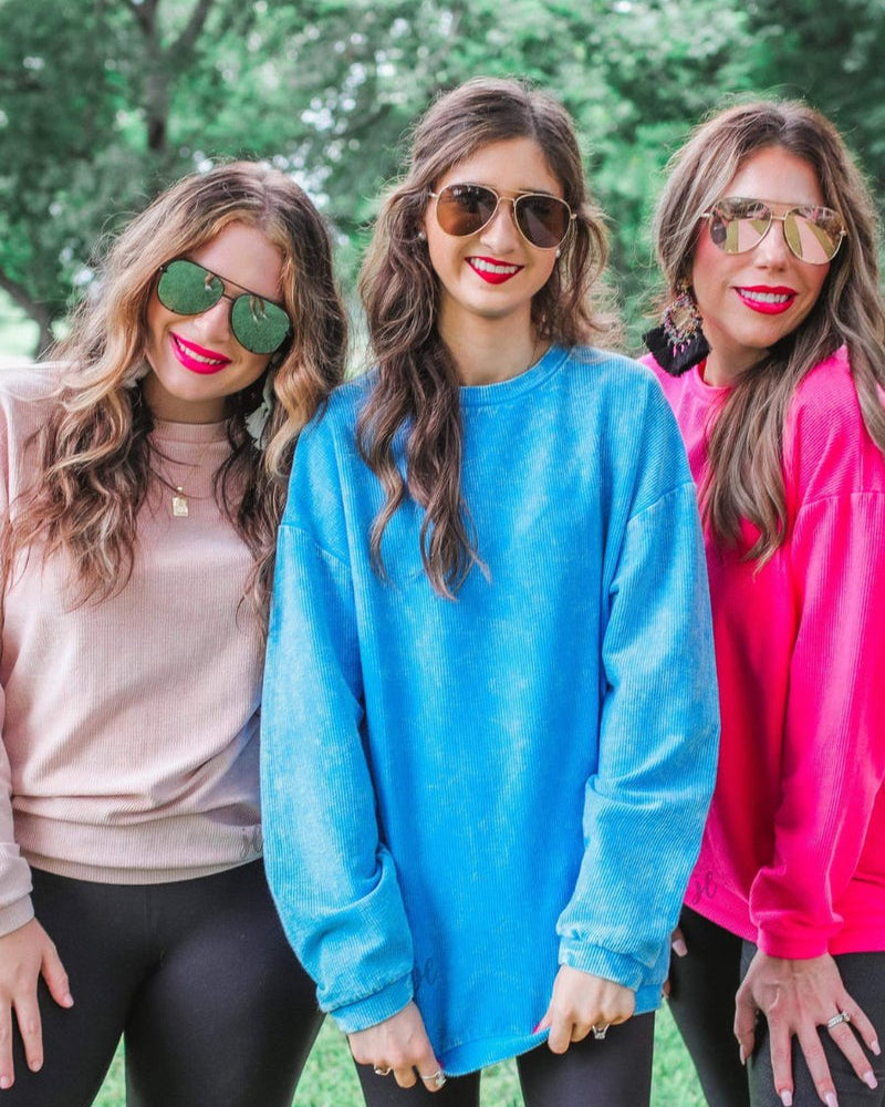 a long-sleeve ribbed textured pullover with a crew neck collar, a vintage wash, and a relaxed fit in blush, blue, and pink