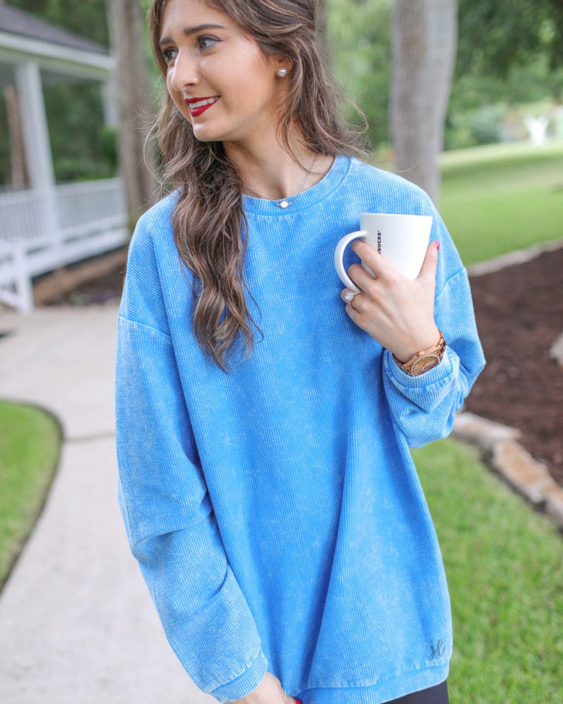 a long-sleeve ribbed textured pullover with a crew neck collar, a vintage wash, and a relaxed fit in blue