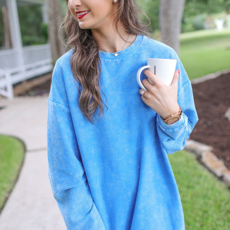 a long-sleeve ribbed textured pullover with a crew neck collar, a vintage wash, and a relaxed fit in blue