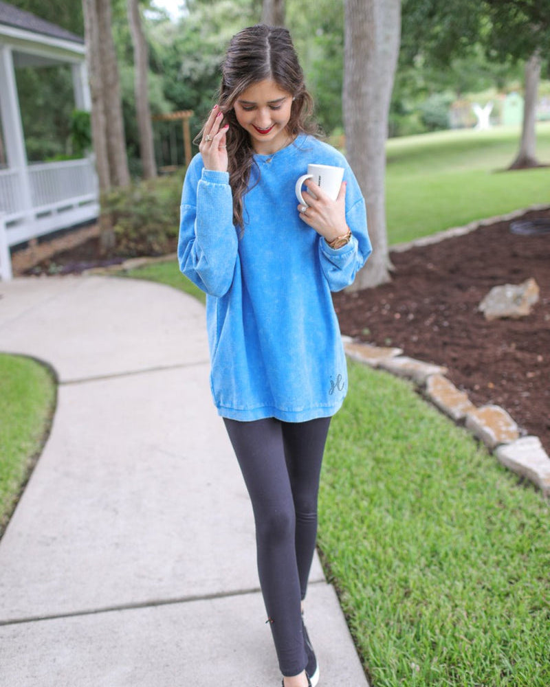 a long-sleeve ribbed textured pullover with a crew neck collar, a vintage wash, and a relaxed fit in blue