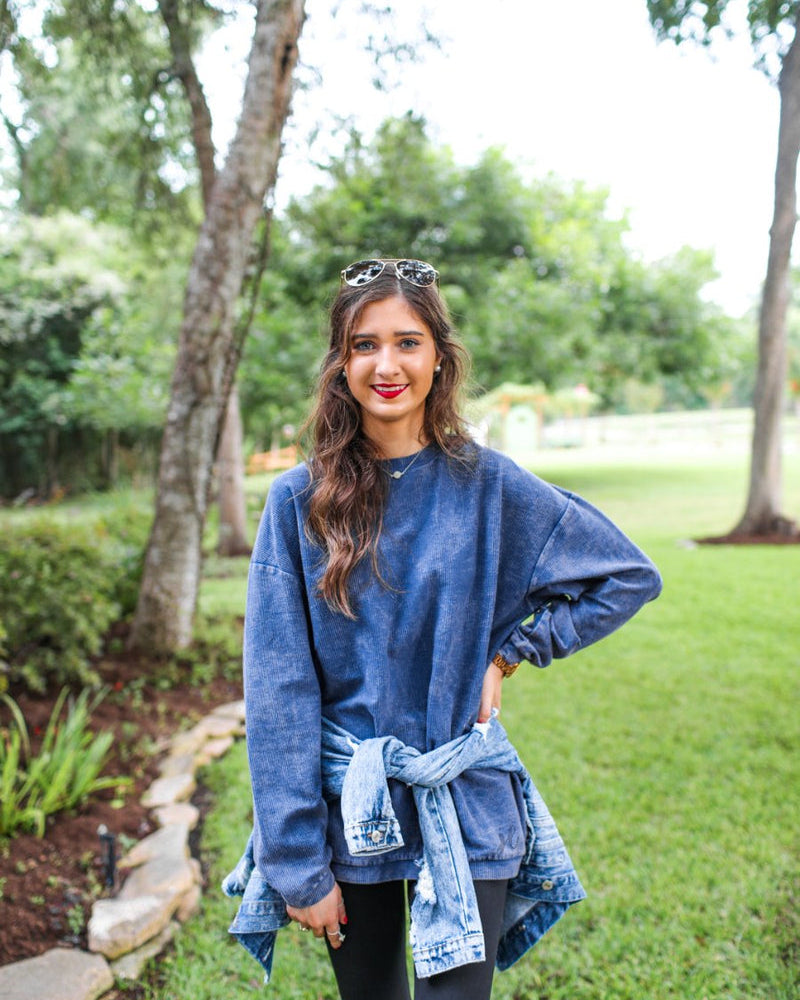 a long-sleeve ribbed textured pullover with a crew neck collar, a vintage wash, and a relaxed fit in navy