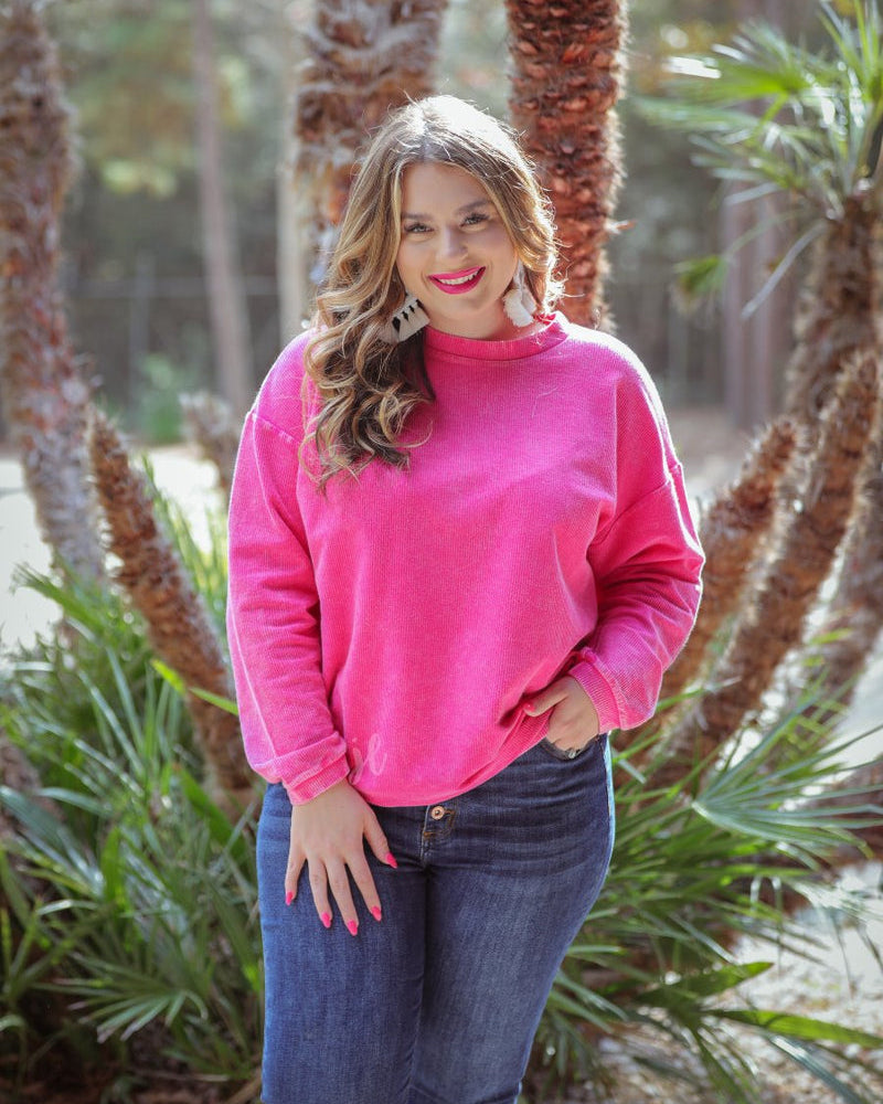 a long-sleeve ribbed textured pullover with a crew neck collar, a vintage wash, and a relaxed fit in pink