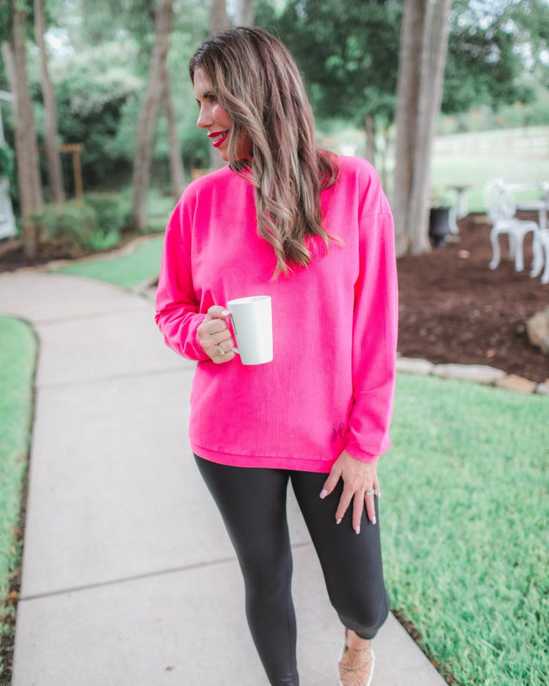 a long-sleeve ribbed textured pullover with a crew neck collar, a vintage wash, and a relaxed fit in pink