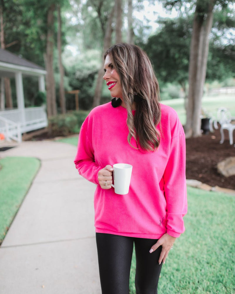 a long-sleeve ribbed textured pullover with a crew neck collar, a vintage wash, and a relaxed fit in pink