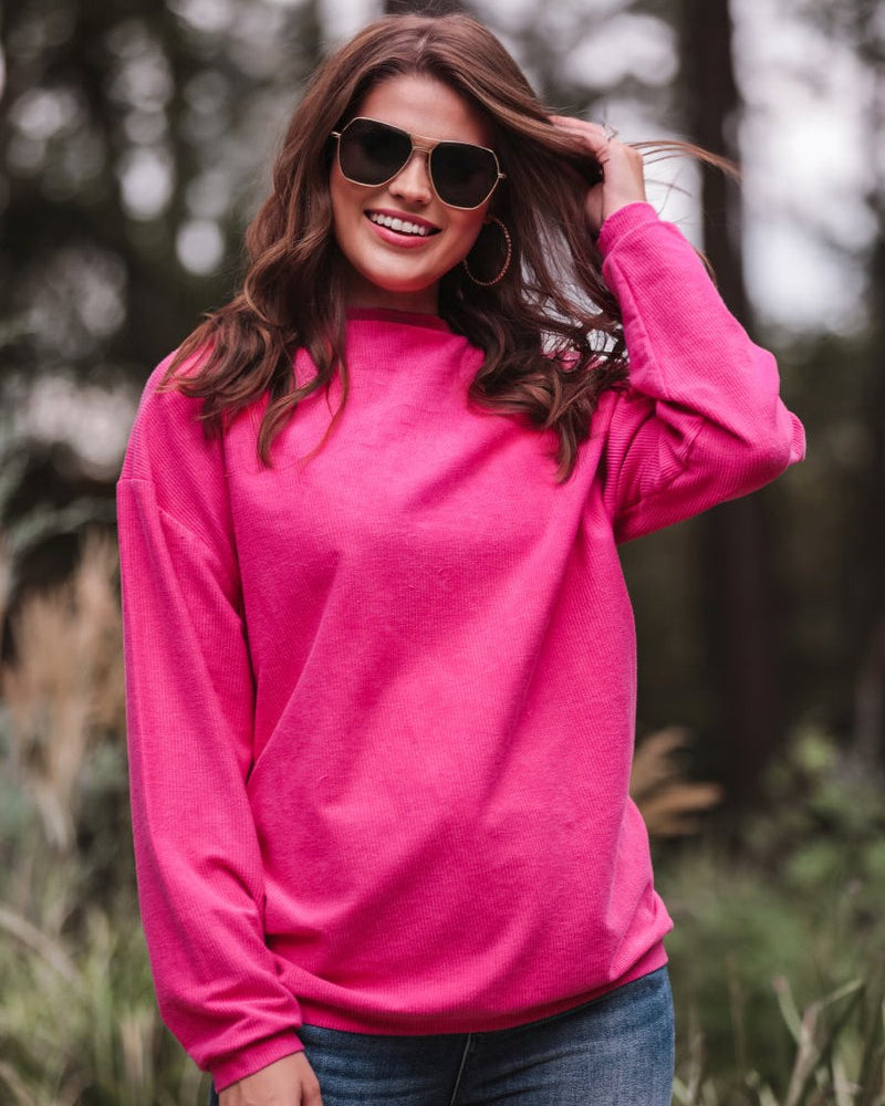 a long-sleeve ribbed textured pullover with a crew neck collar, a vintage wash, and a relaxed fit in pink