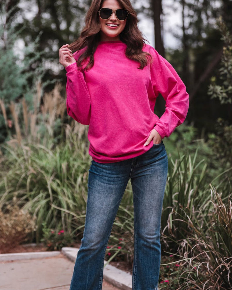 a long-sleeve ribbed textured pullover with a crew neck collar, a vintage wash, and a relaxed fit in pink