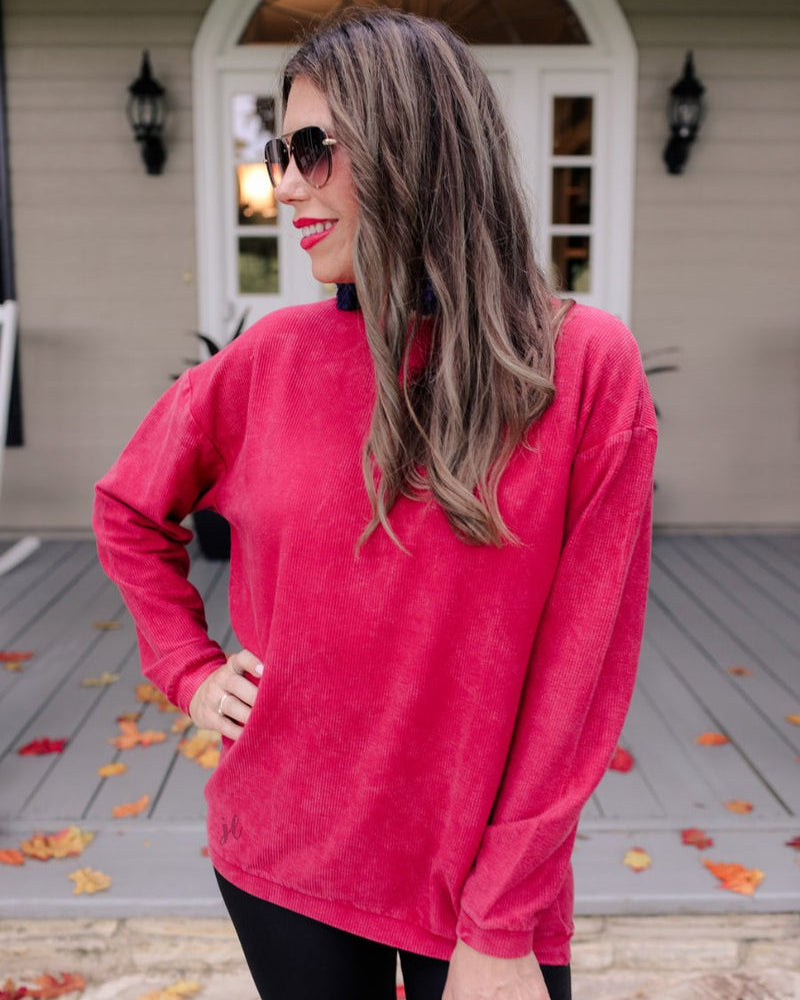 a long-sleeve ribbed textured pullover with a crew neck collar, a vintage wash, and a relaxed fit in red