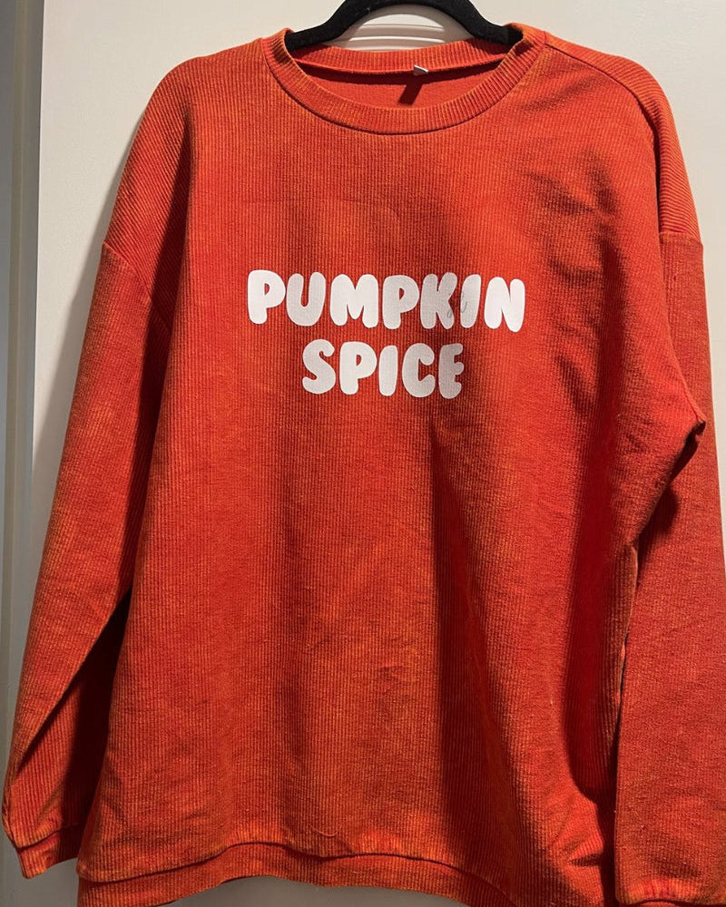 a long-sleeve ribbed textured pullover with a crew neck collar, a vintage wash, and a relaxed fit in rust