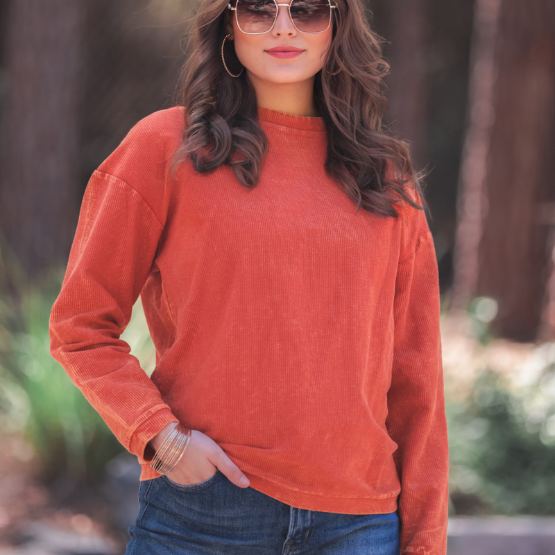 a long-sleeve ribbed textured pullover with a crew neck collar, a vintage wash, and a relaxed fit in rust