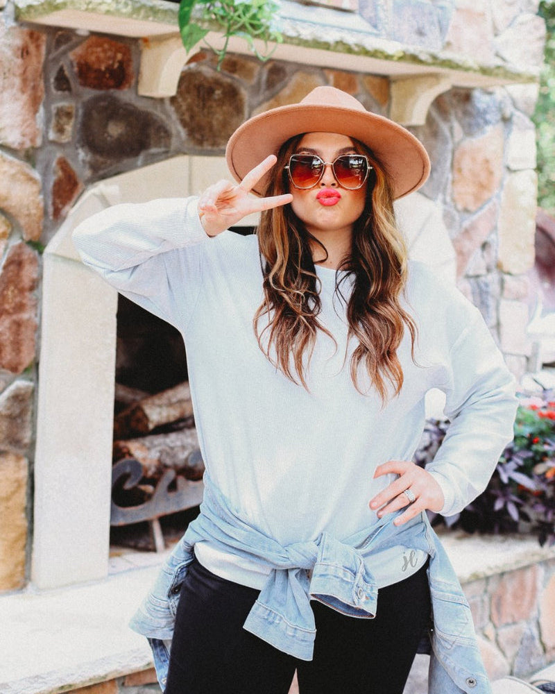 a long-sleeve ribbed textured pullover with a crew neck collar, a vintage wash, and a relaxed fit in silver