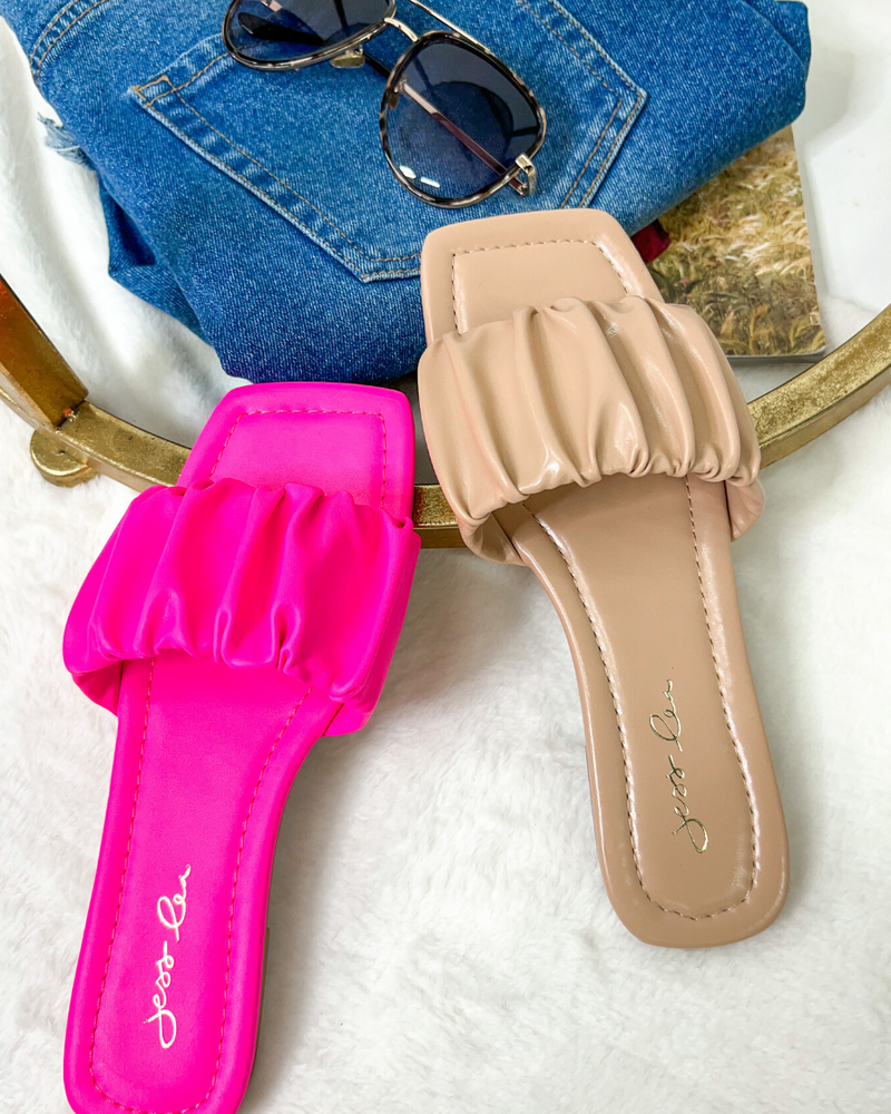 ruched slip-on sandals with an open toe and flat sole in pink and neutral