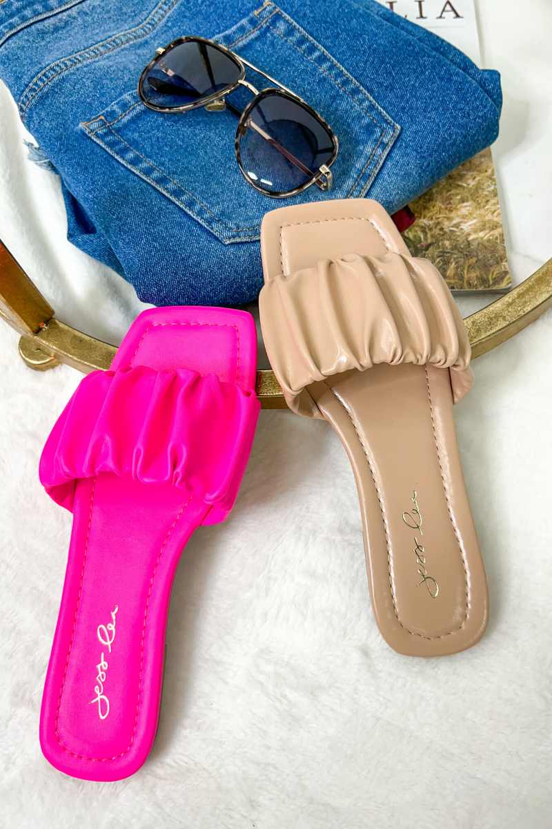 ruched slip-on sandals with an open toe and flat sole in pink and neutral