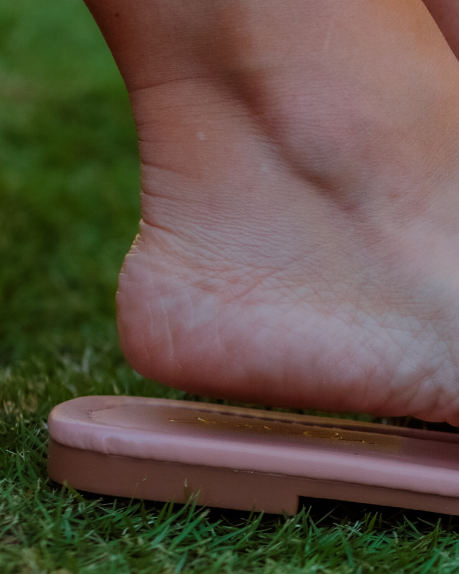 ruched slip-on sandals with an open toe and flat sole in neutral