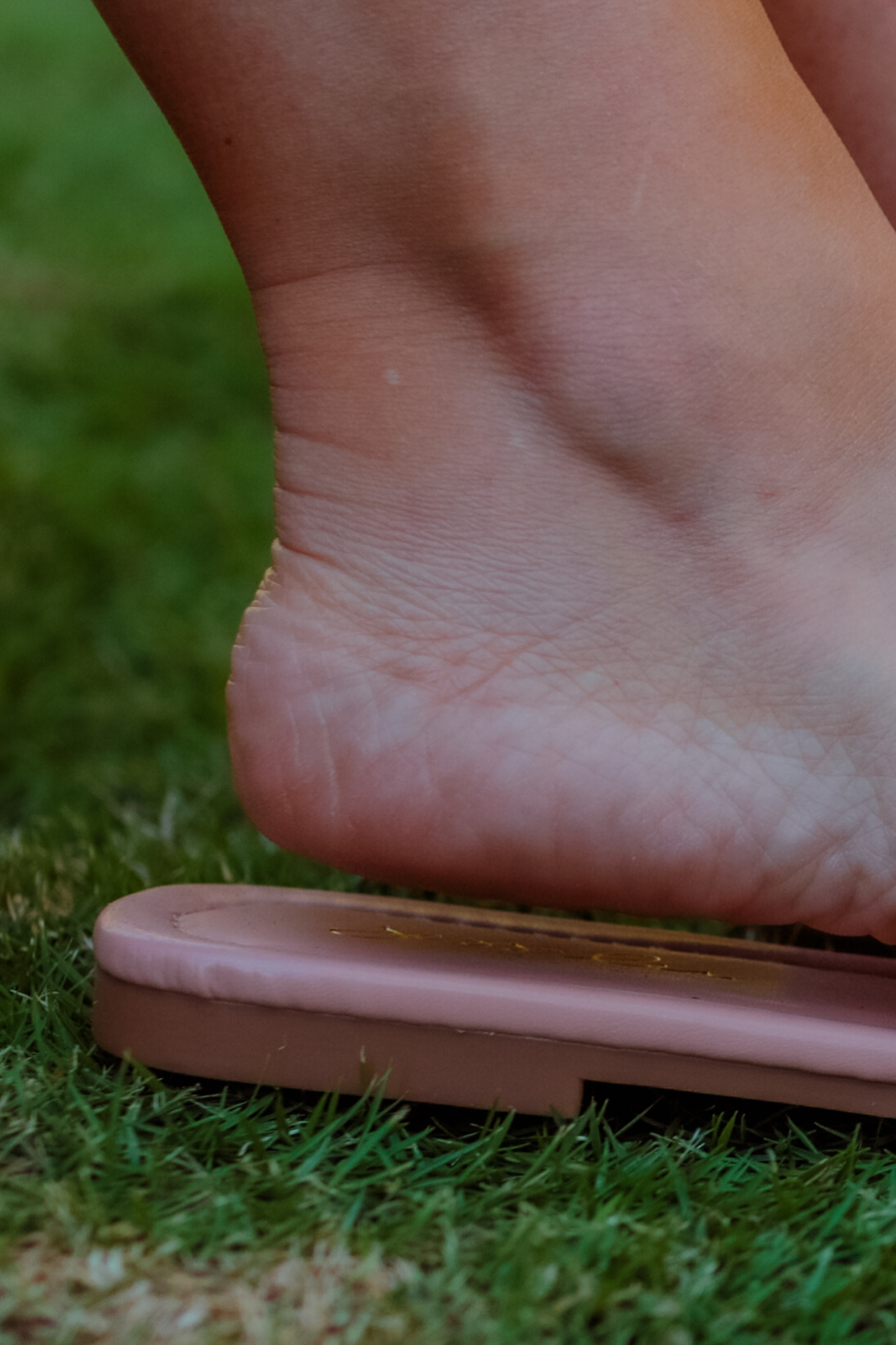 ruched slip-on sandals with an open toe and flat sole in neutral