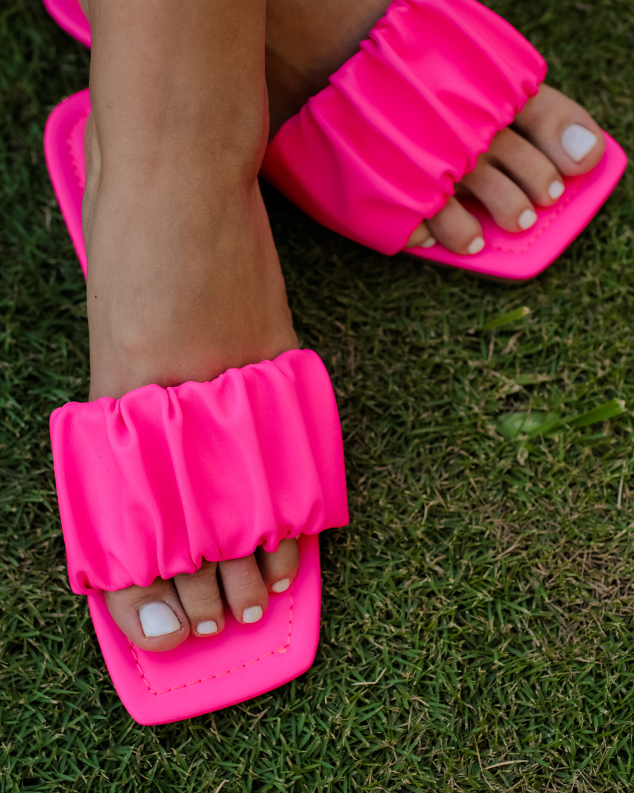 ruched slip-on sandals with an open toe and flat sole in pink