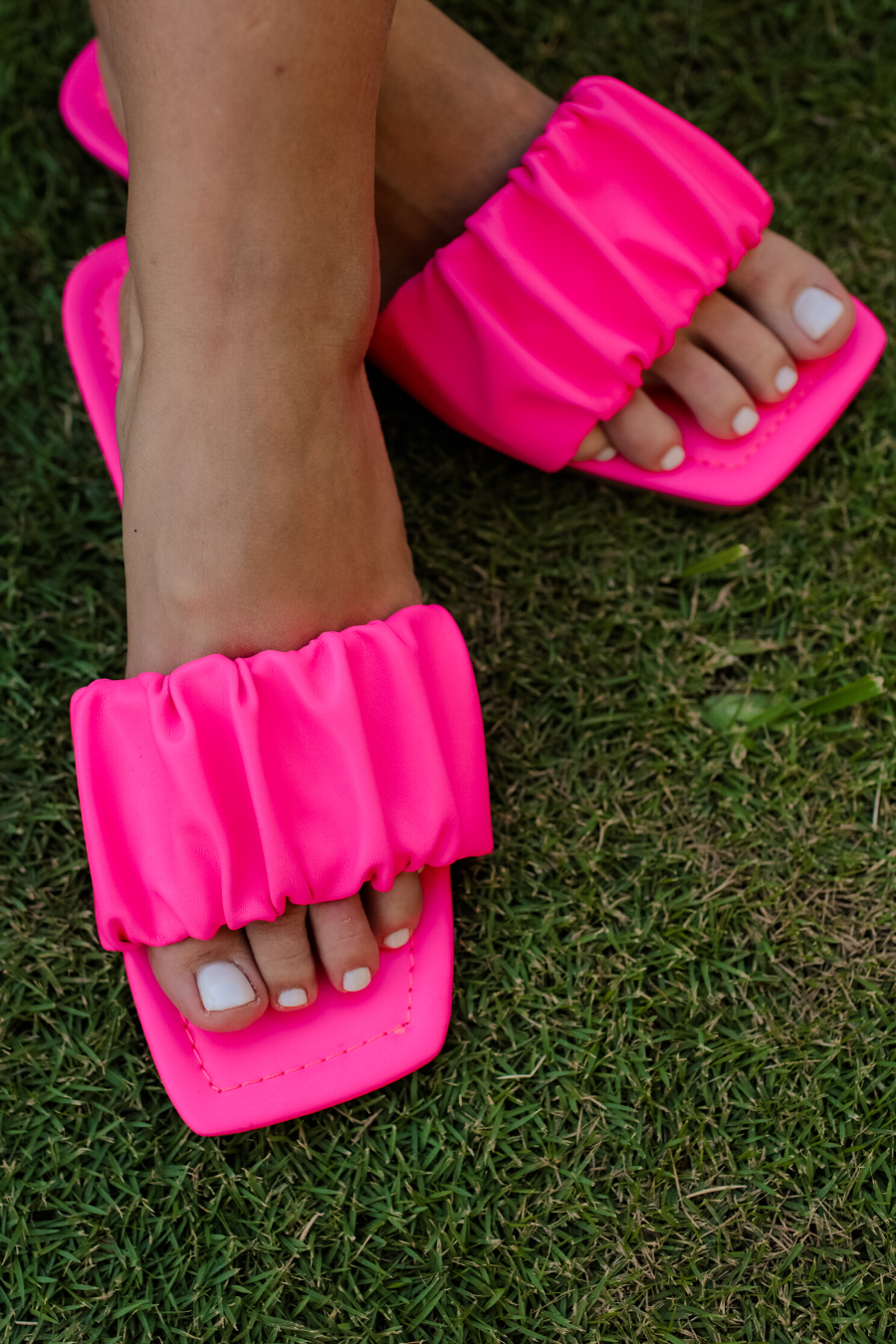 ruched slip-on sandals with an open toe and flat sole in pink