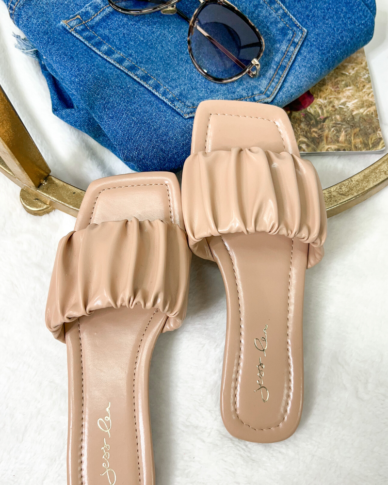 ruched slip-on sandals with an open toe and flat sole in neutral