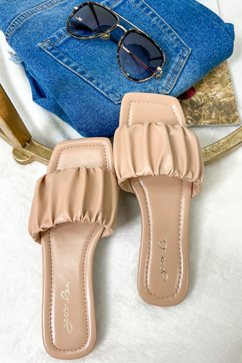 ruched slip-on sandals with an open toe and flat sole in neutral
