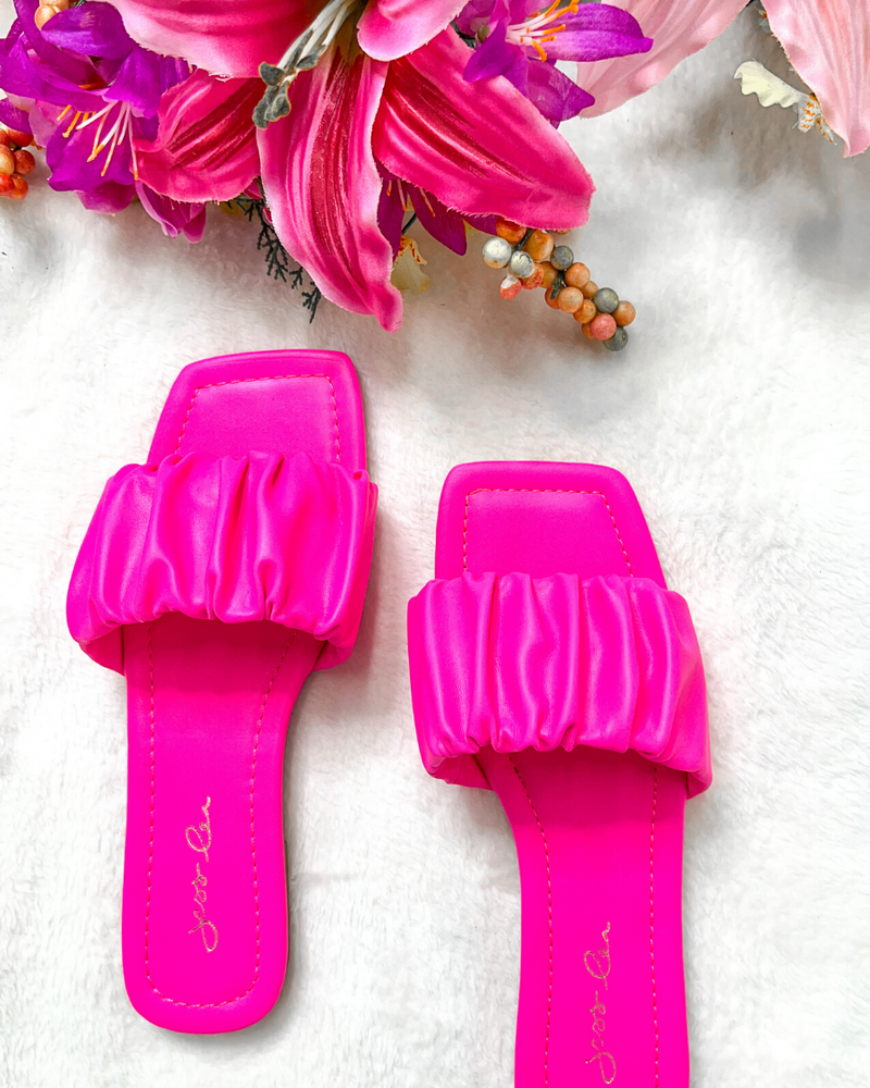 ruched slip-on sandals with an open toe and flat sole in pink