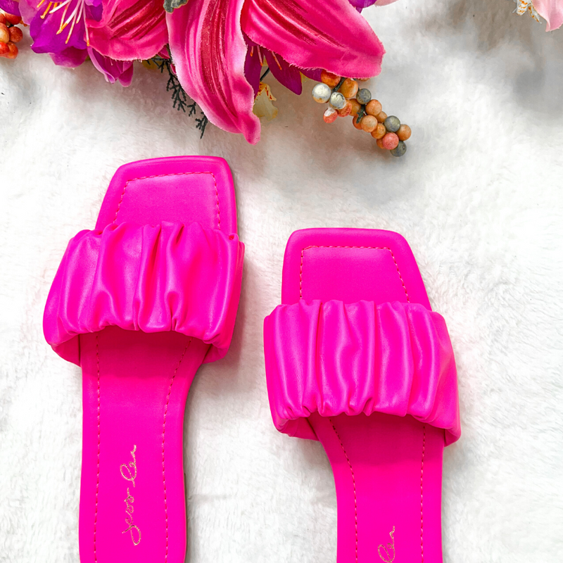 ruched slip-on sandals with an open toe and flat sole in pink