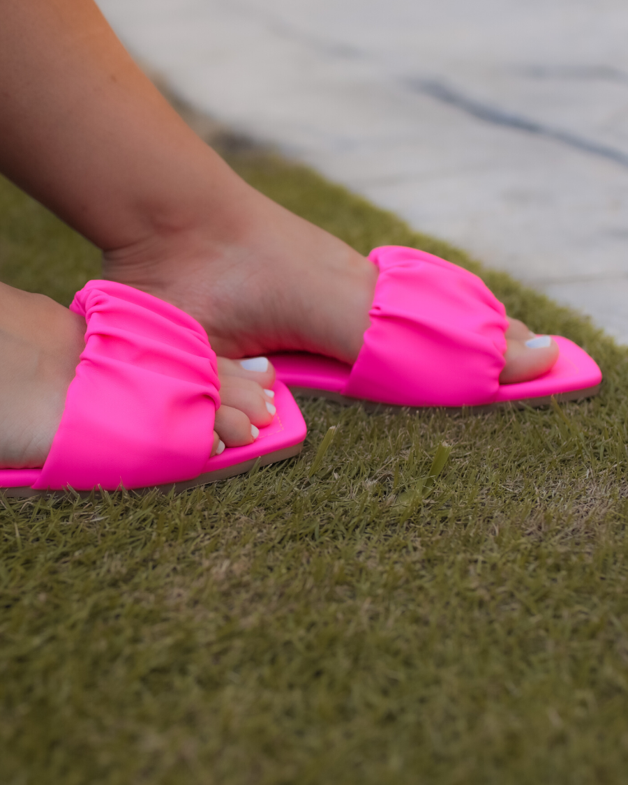 ruched slip-on sandals with an open toe and flat sole in pink