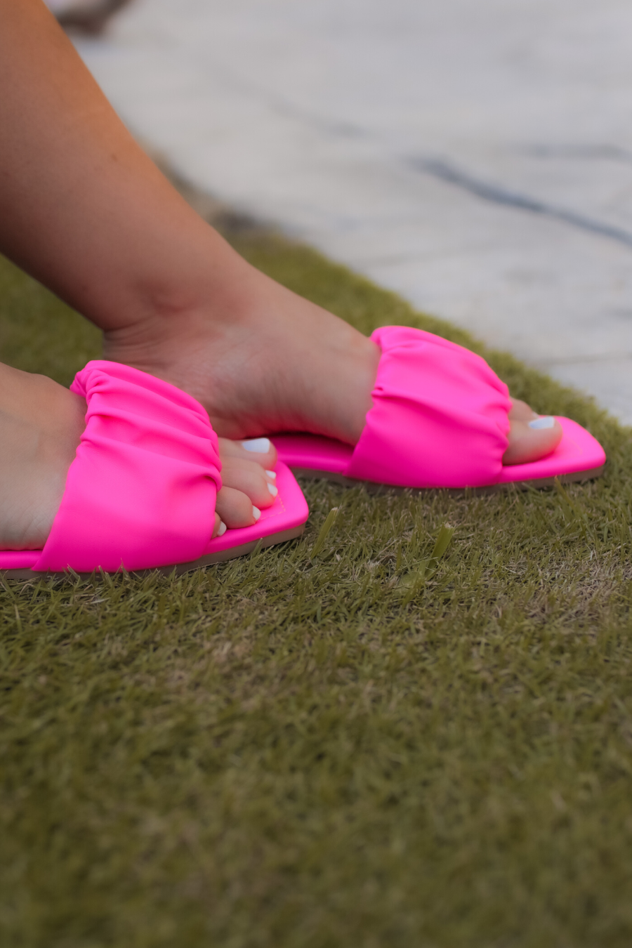 ruched slip-on sandals with an open toe and flat sole in pink