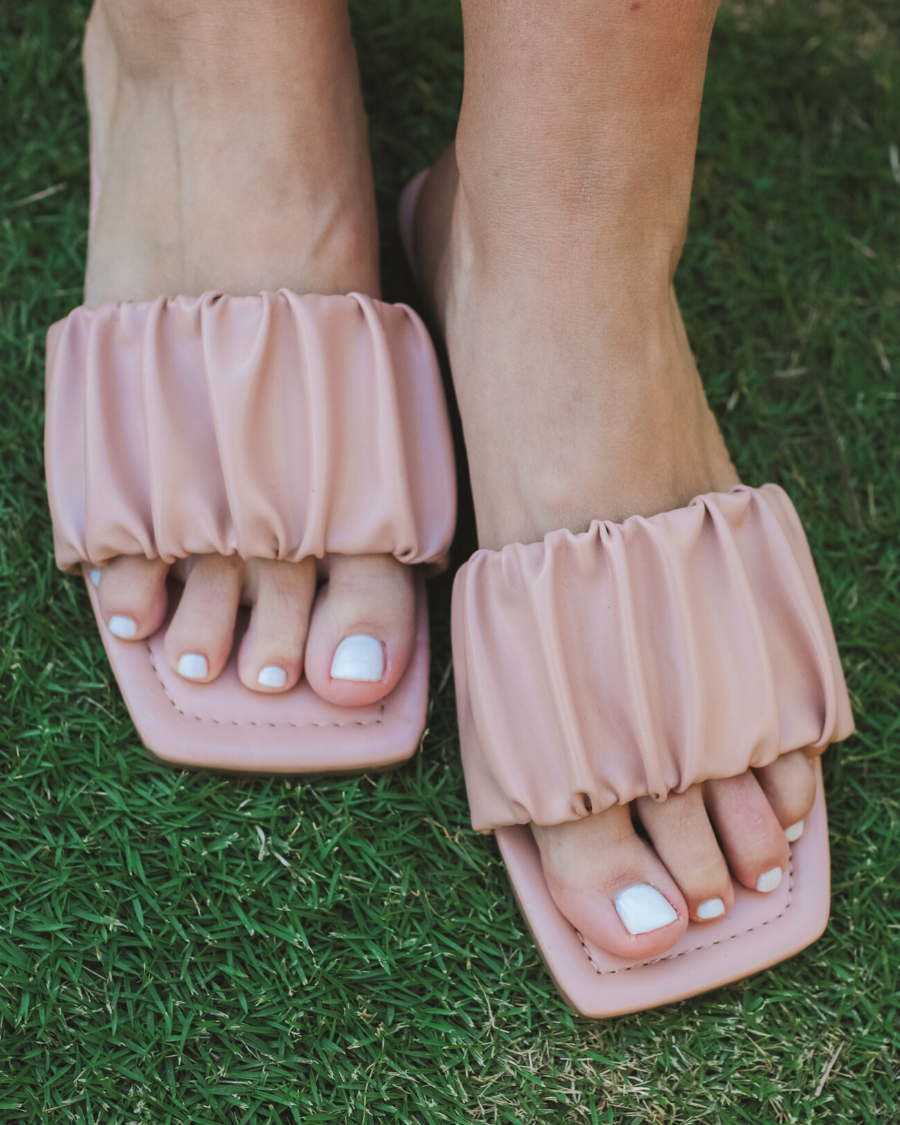 ruched slip-on sandals with an open toe and flat sole in neutral