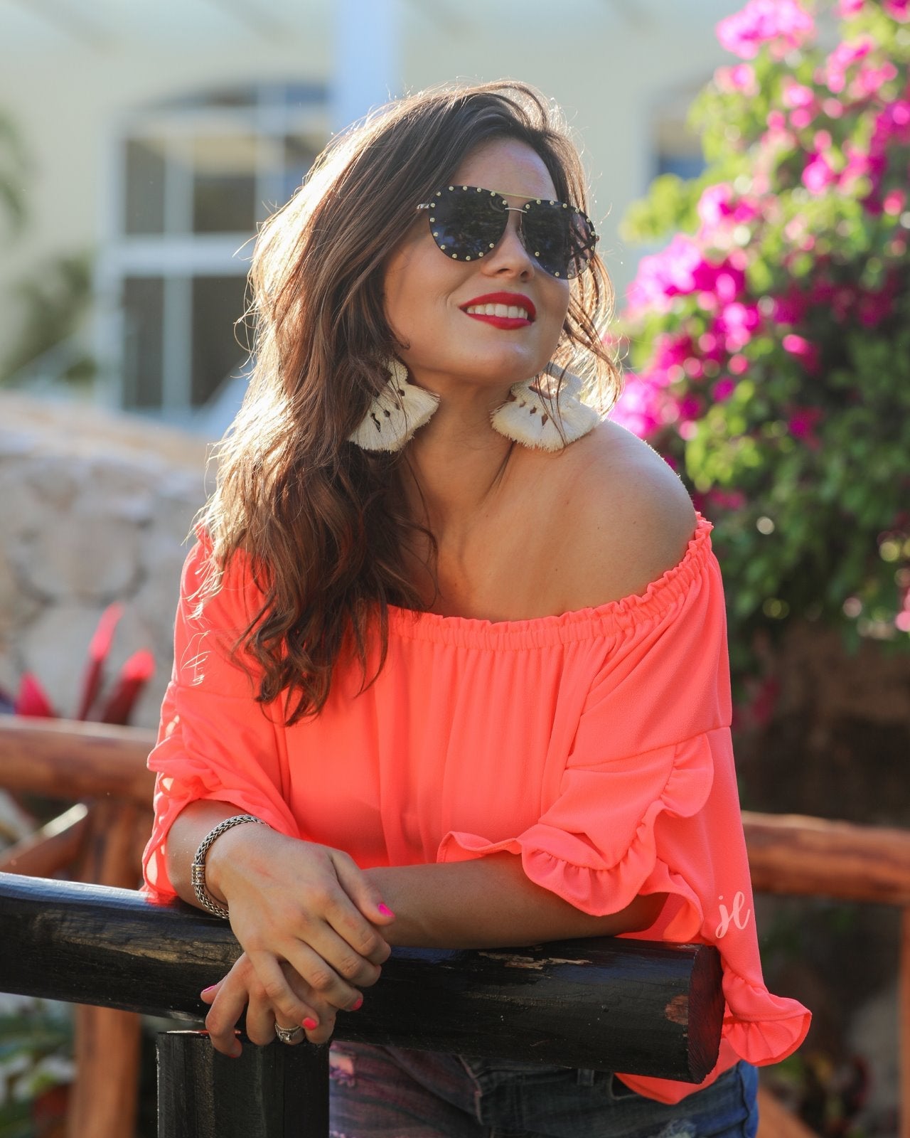 a flowy style top with a gathered scoop neckline that can be worn on or off the shoulder and three-quarter split ruffle sleeves in coral