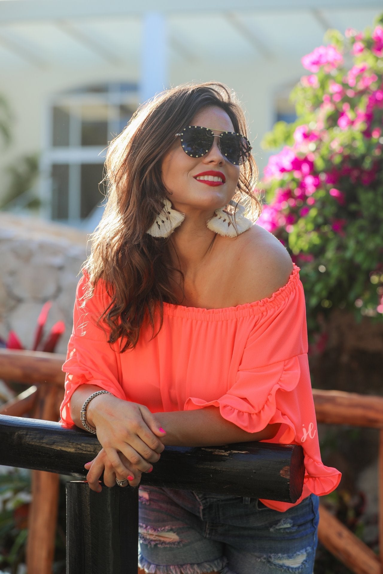 a flowy style top with a gathered scoop neckline that can be worn on or off the shoulder and three-quarter split ruffle sleeves in coral