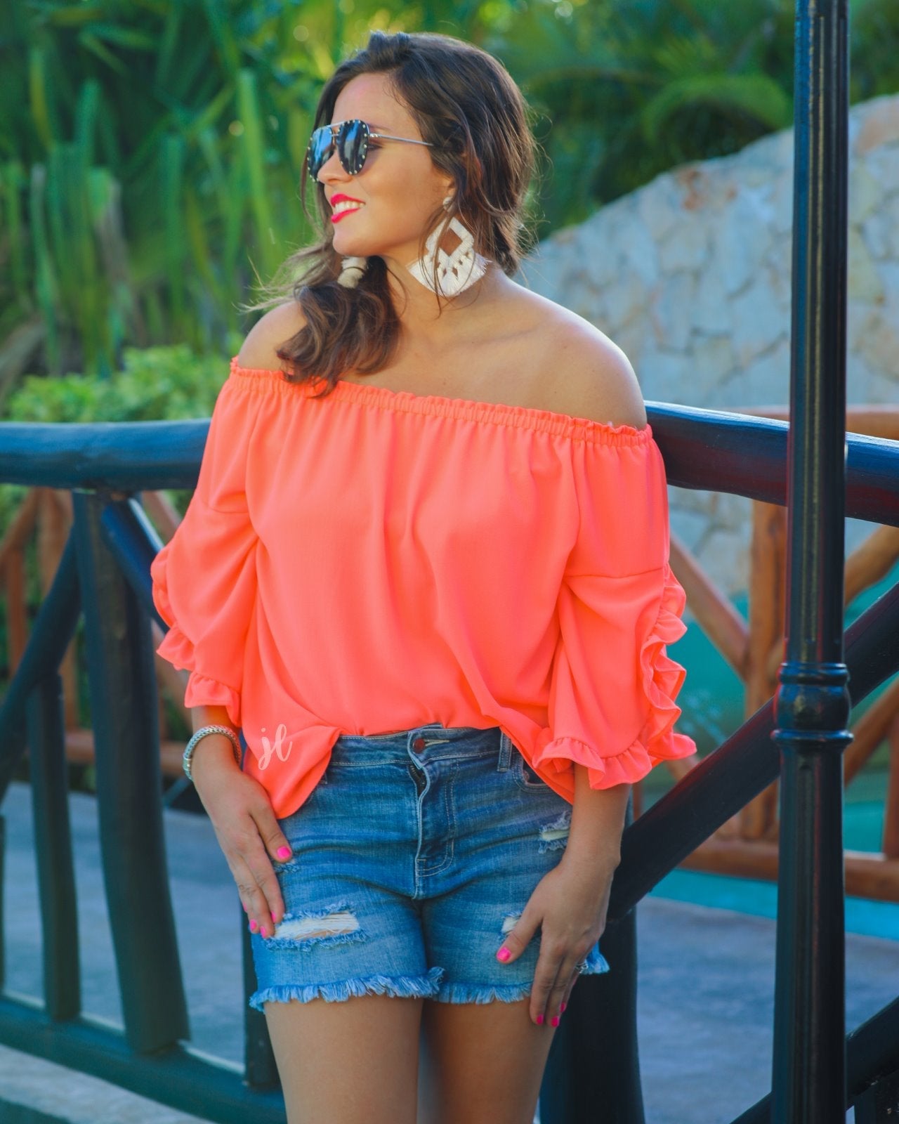 a flowy style top with a gathered scoop neckline that can be worn on or off the shoulder and three-quarter split ruffle sleeves in coral
