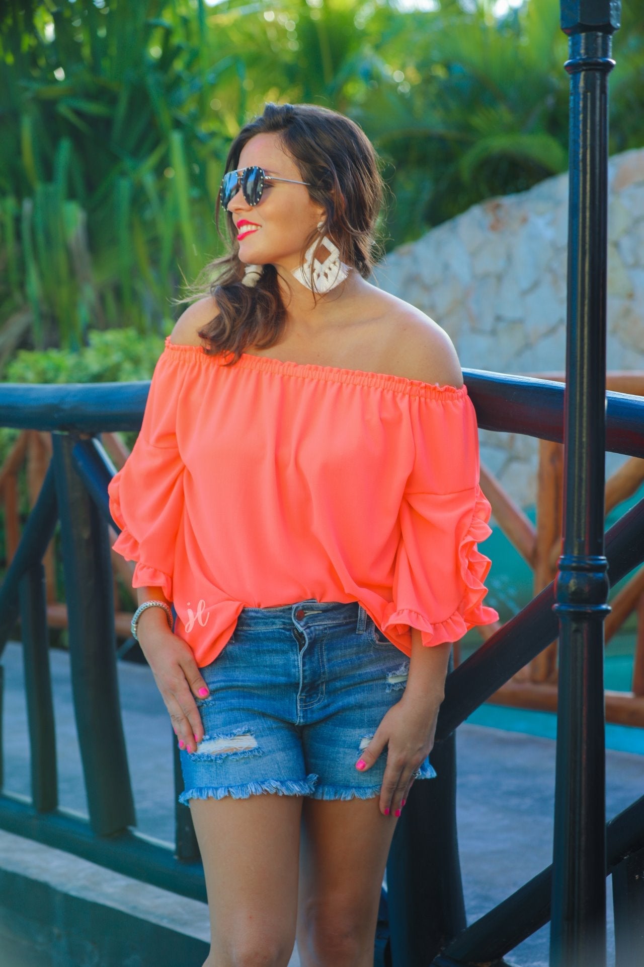a flowy style top with a gathered scoop neckline that can be worn on or off the shoulder and three-quarter split ruffle sleeves in coral