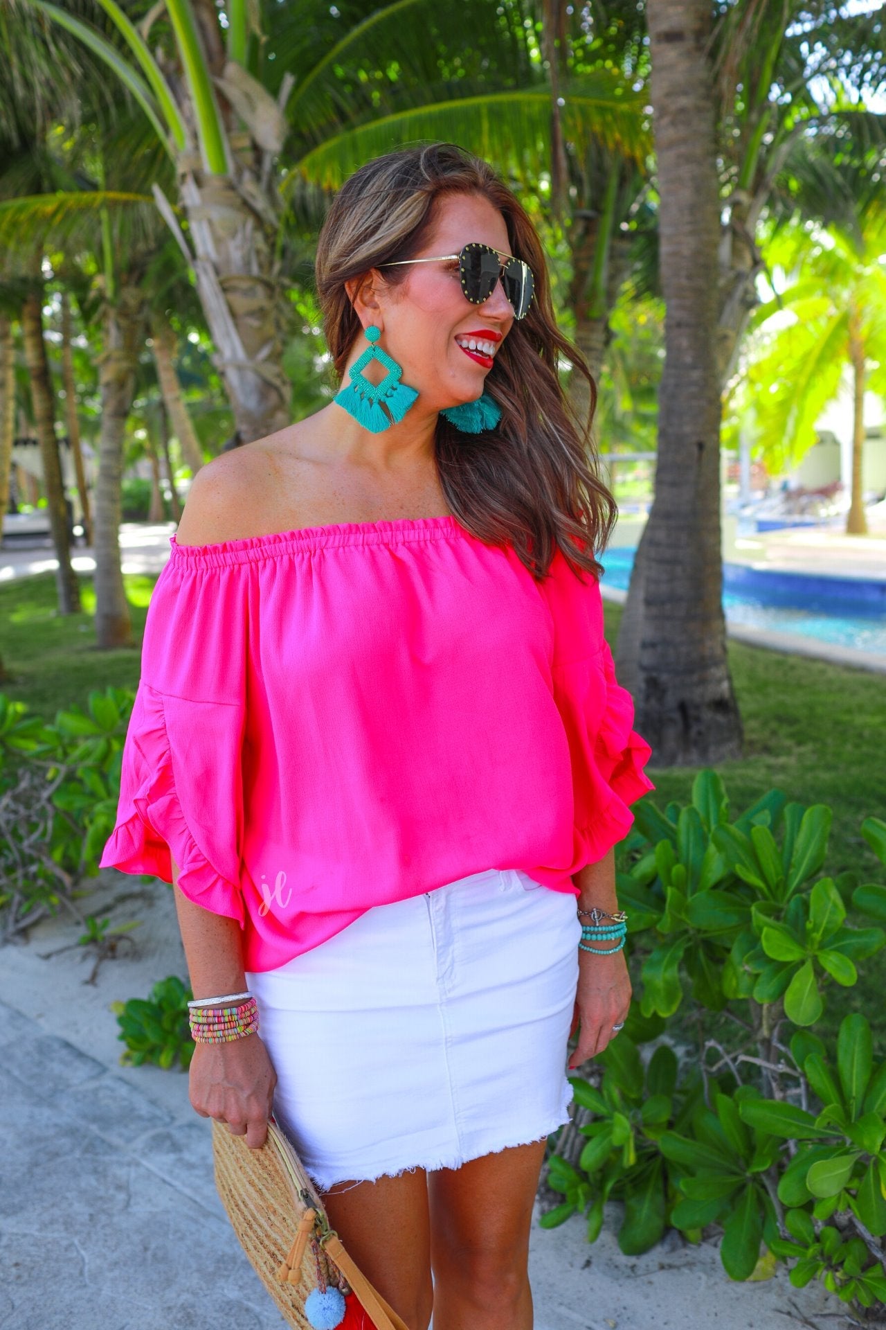 a flowy style top with a gathered scoop neckline that can be worn on or off the shoulder and three-quarter split ruffle sleeves in pink