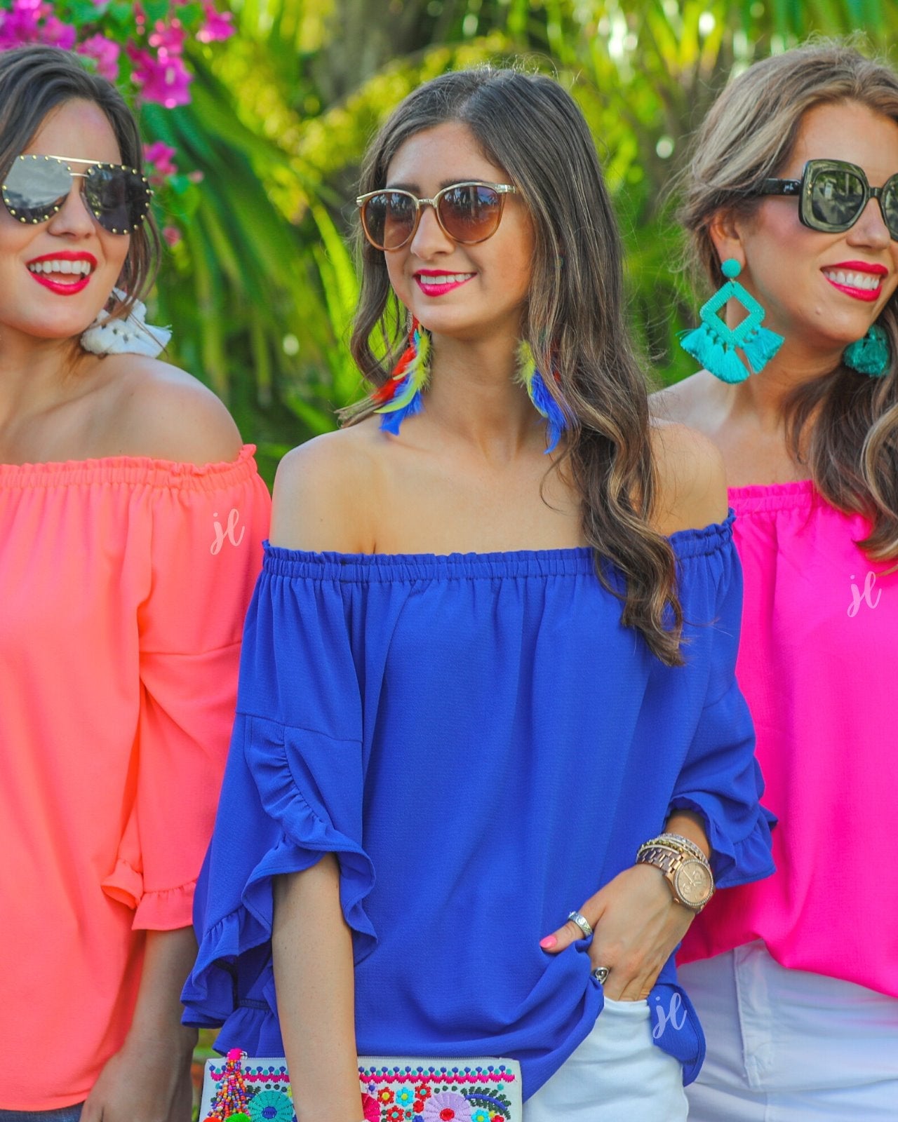 a flowy style top with a gathered scoop neckline that can be worn on or off the shoulder and three-quarter split ruffle sleeves in blue, coral, and pink