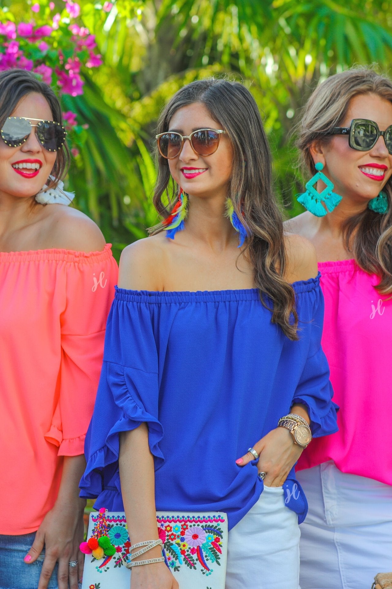 a flowy style top with a gathered scoop neckline that can be worn on or off the shoulder and three-quarter split ruffle sleeves in blue, coral, and pink