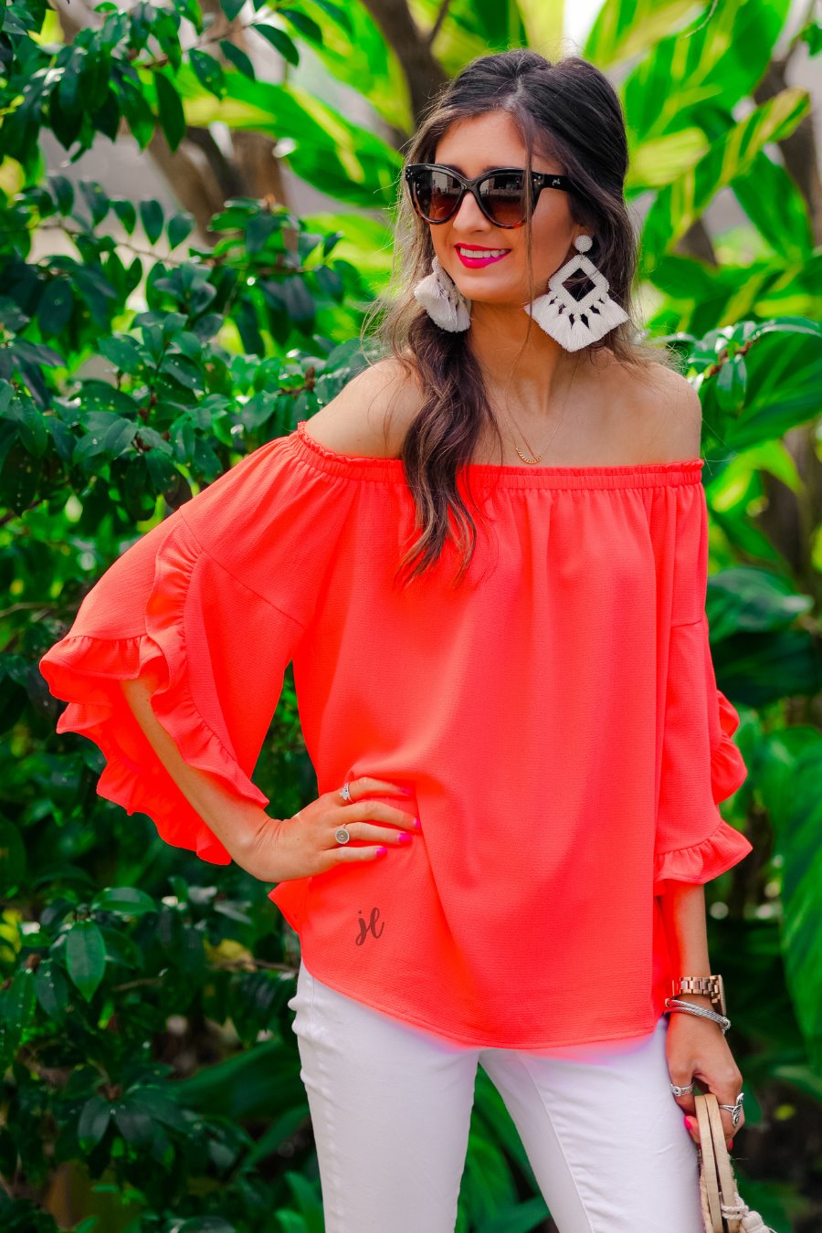 a flowy style top with a gathered scoop neckline that can be worn on or off the shoulder and three-quarter split ruffle sleeves in coral