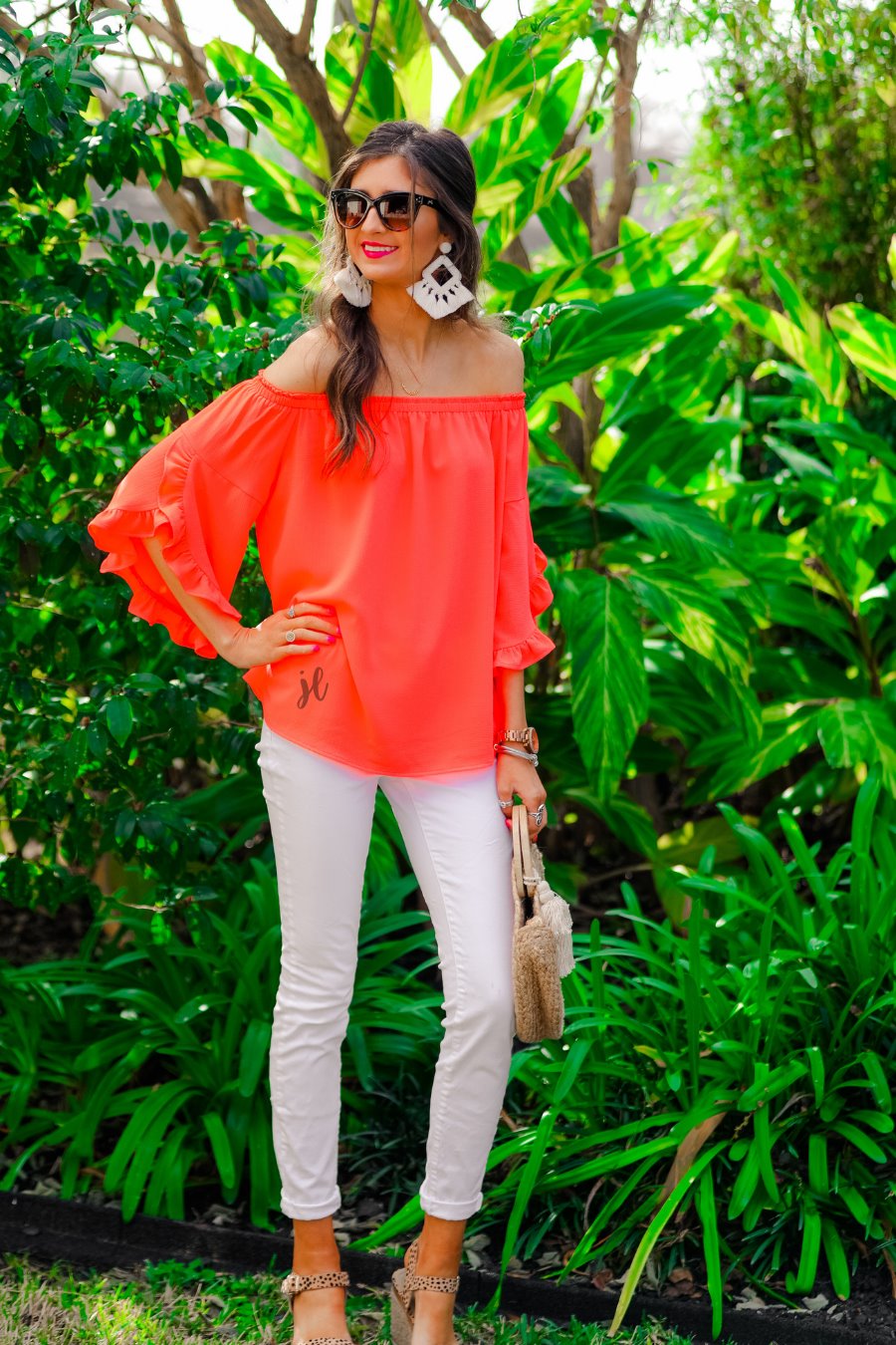 a flowy style top with a gathered scoop neckline that can be worn on or off the shoulder and three-quarter split ruffle sleeves in coral