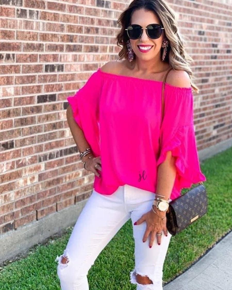 a flowy style top with a gathered scoop neckline that can be worn on or off the shoulder and three-quarter split ruffle sleeves in pink
