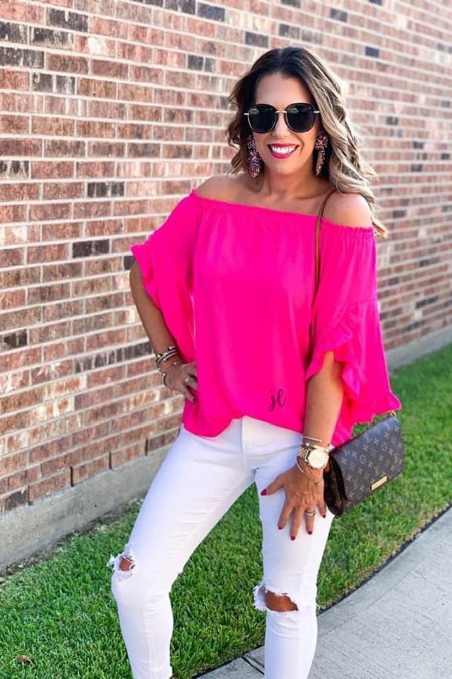 a flowy style top with a gathered scoop neckline that can be worn on or off the shoulder and three-quarter split ruffle sleeves in pink