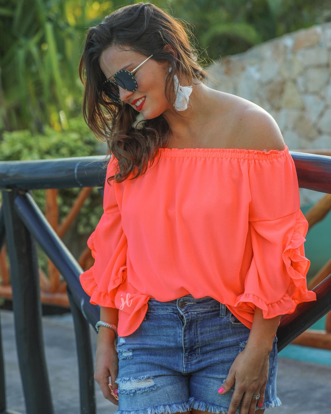 a flowy style top with a gathered scoop neckline that can be worn on or off the shoulder and three-quarter split ruffle sleeves in coral