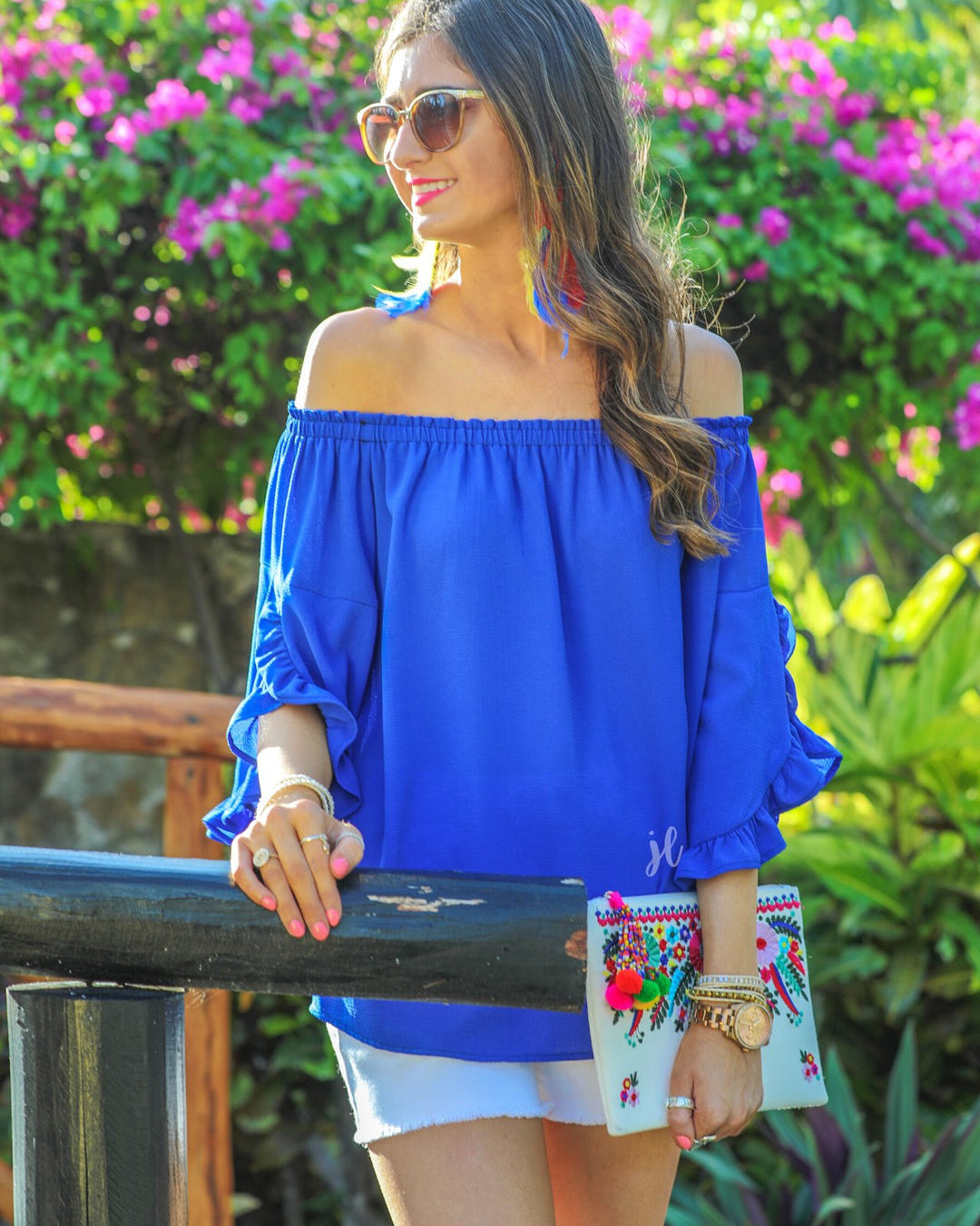 a flowy style top with a gathered scoop neckline that can be worn on or off the shoulder and three-quarter split ruffle sleeves in blue