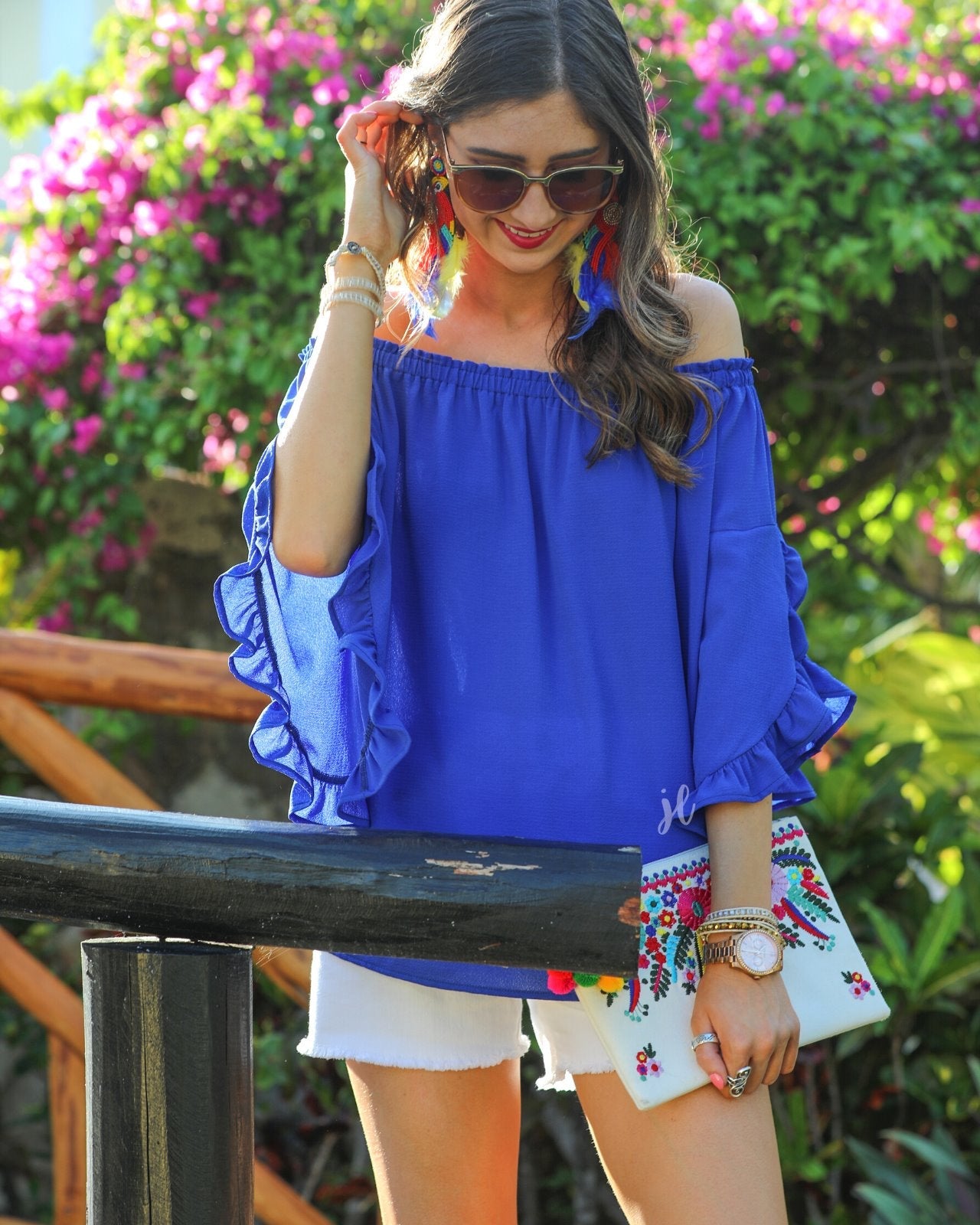 a flowy style top with a gathered scoop neckline that can be worn on or off the shoulder and three-quarter split ruffle sleeves in blue