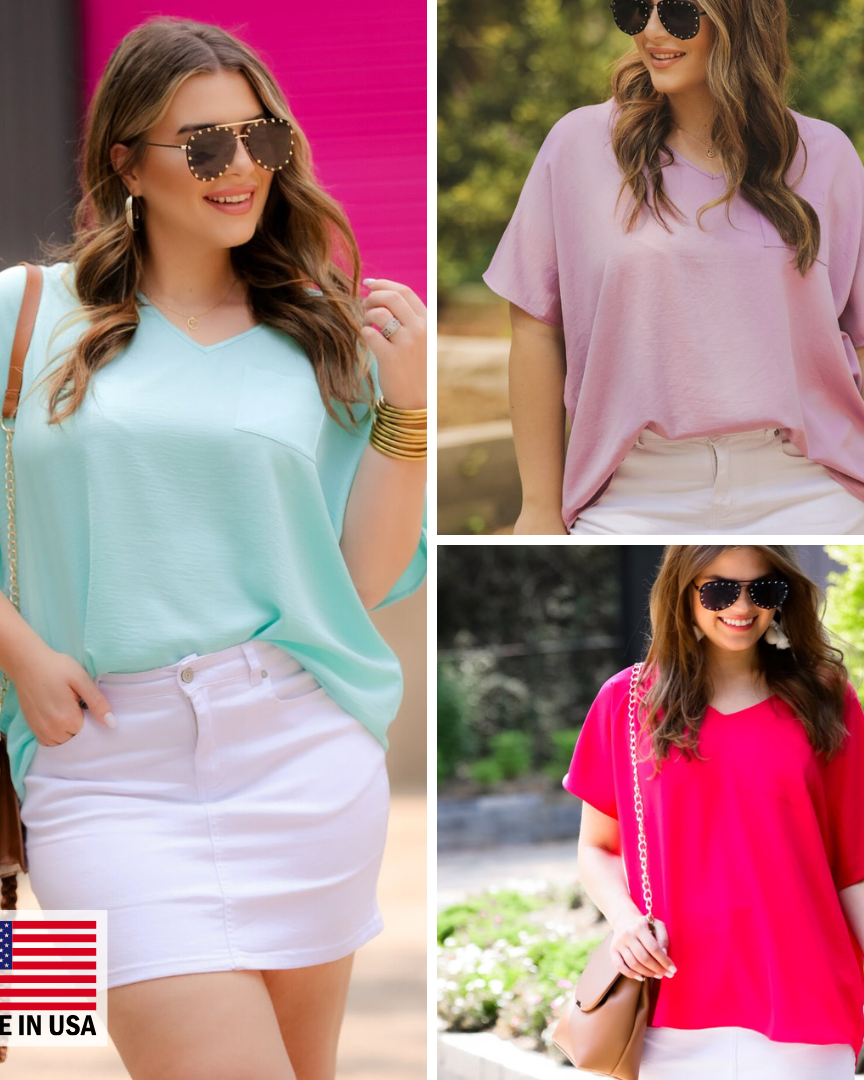a lightweight short-sleeve woven tunic with a V-neckline, a front chest pocket, and a relaxed, non-stretch silhouette in aqua, lilac, and magenta, accented with a MADE IN USA watermark in the bottom left-hand corner