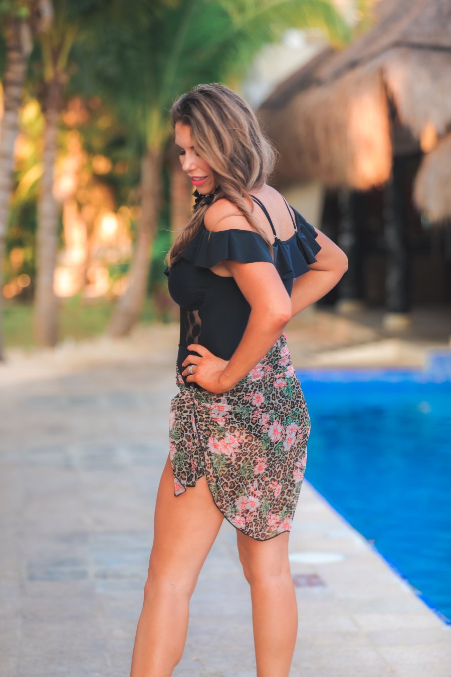 an ultra-lightweight black mesh sarong with a soft flowing drape, a floral and leopard print mix, and versatile styling options